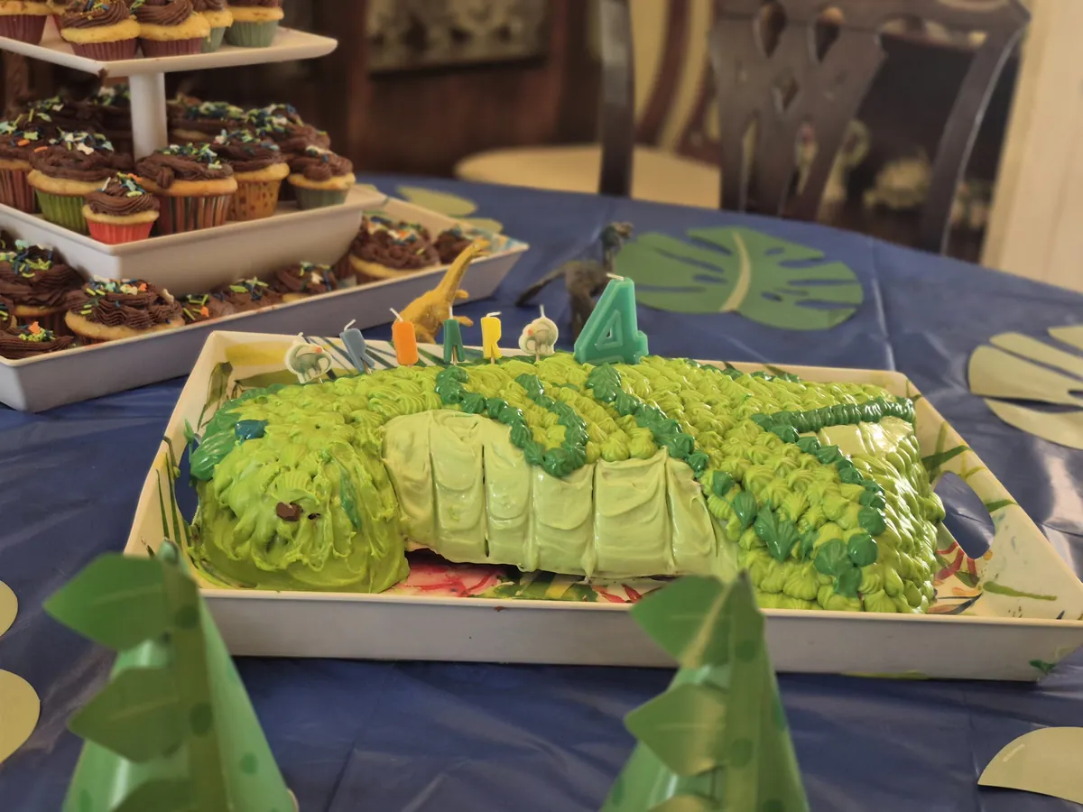 Close-up of green dinosaur cake for a fourth birthday party